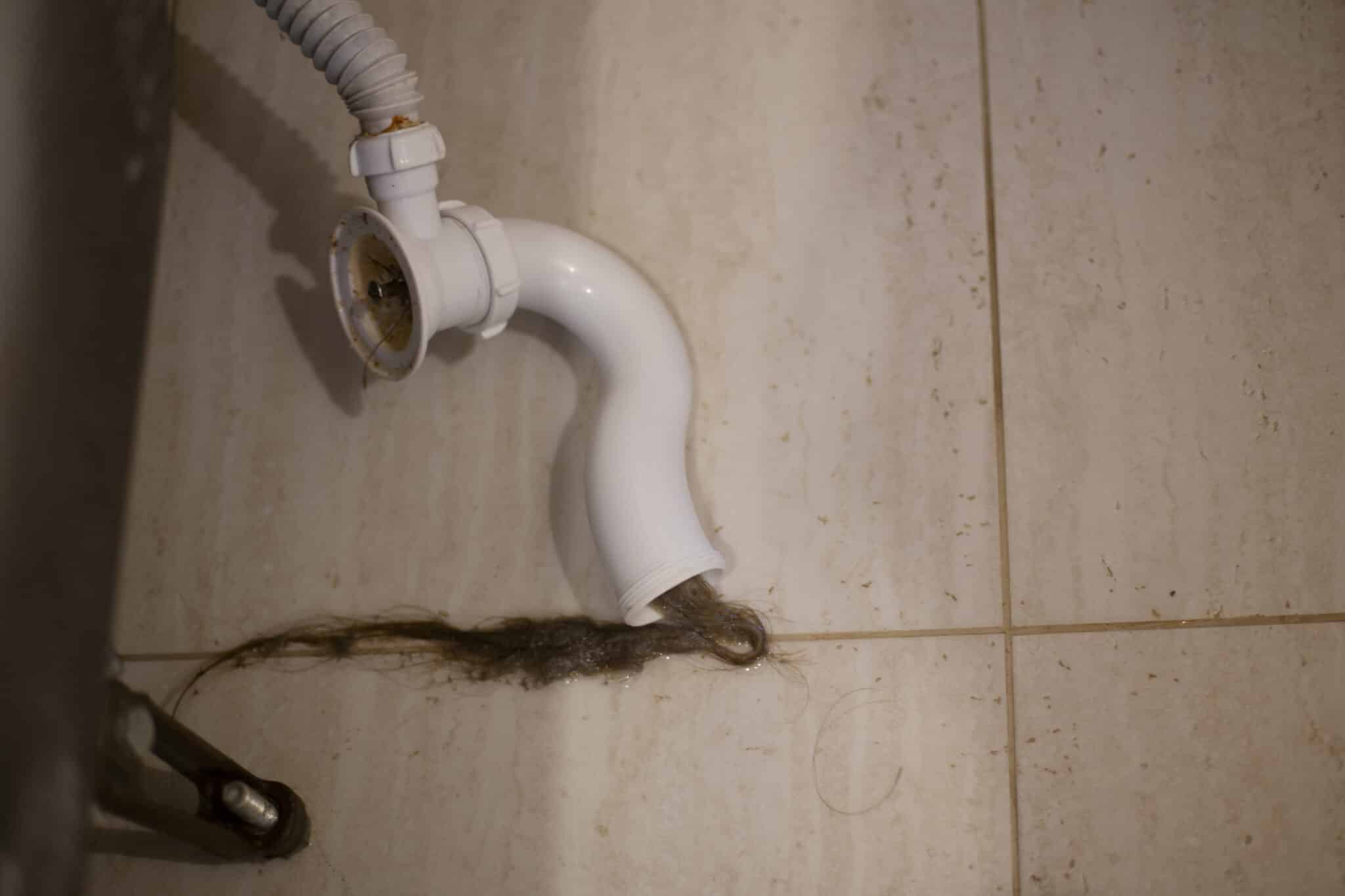 Dirty and hair-clogged pipe in the bathroom, Emergency Drain Clogs.