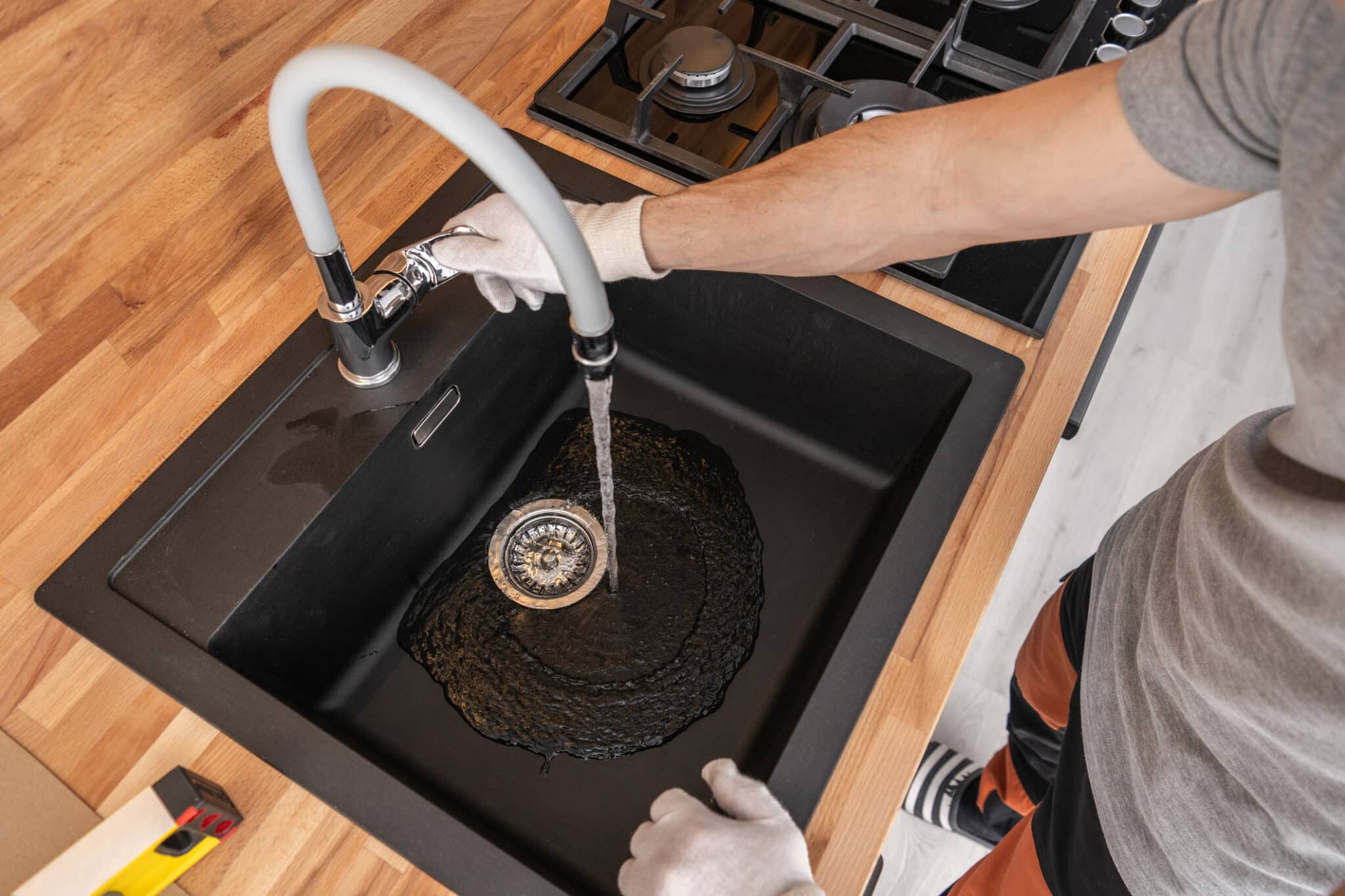 Plumber checking kitchen water supply. Testing sink faucet, Kitchen Plumbing Fixtures.