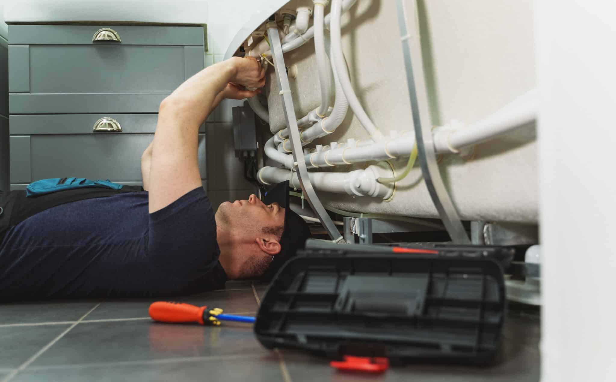 Plumber installing pipe system of bathtub, Plumbing Contractor.