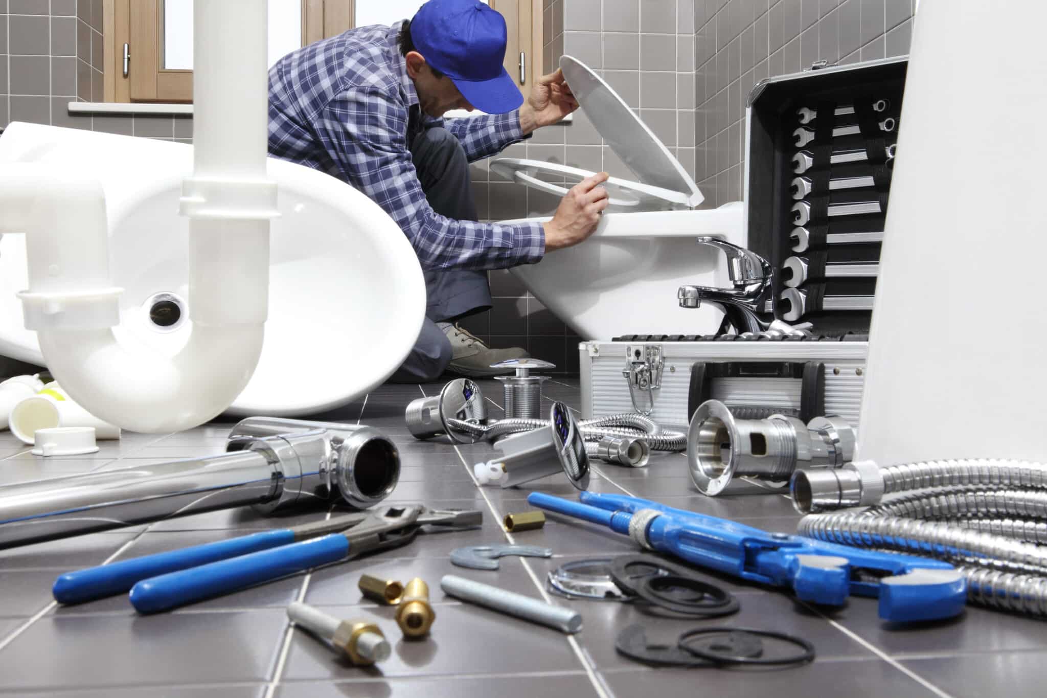 Plumber at work in a bathroom, plumbing repair service, assemble and install concept, Bathroom Plumbing Renovation.