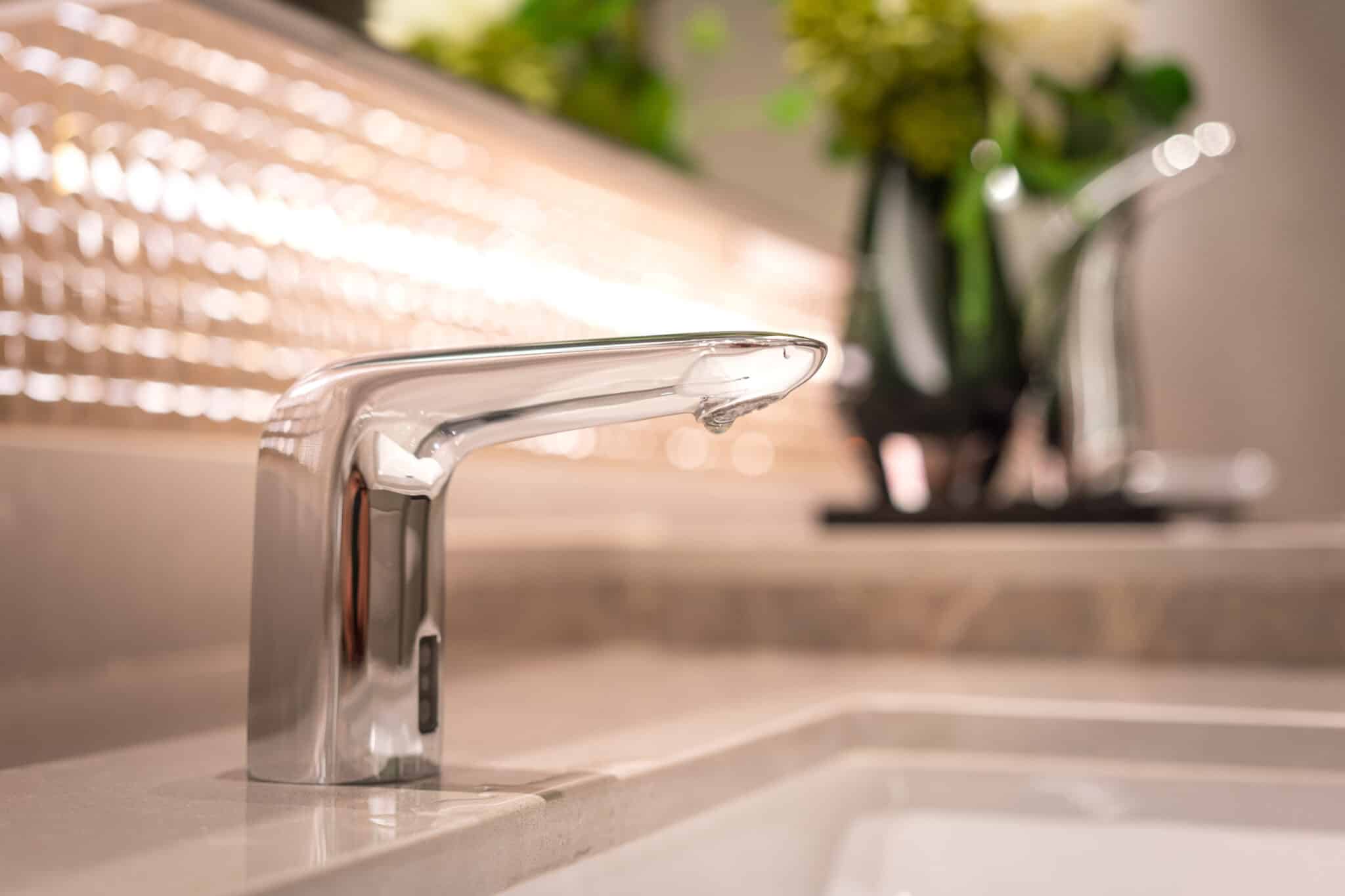 A luxury automatic hand washing faucet with background, Bathroom Plumbing Renovation.