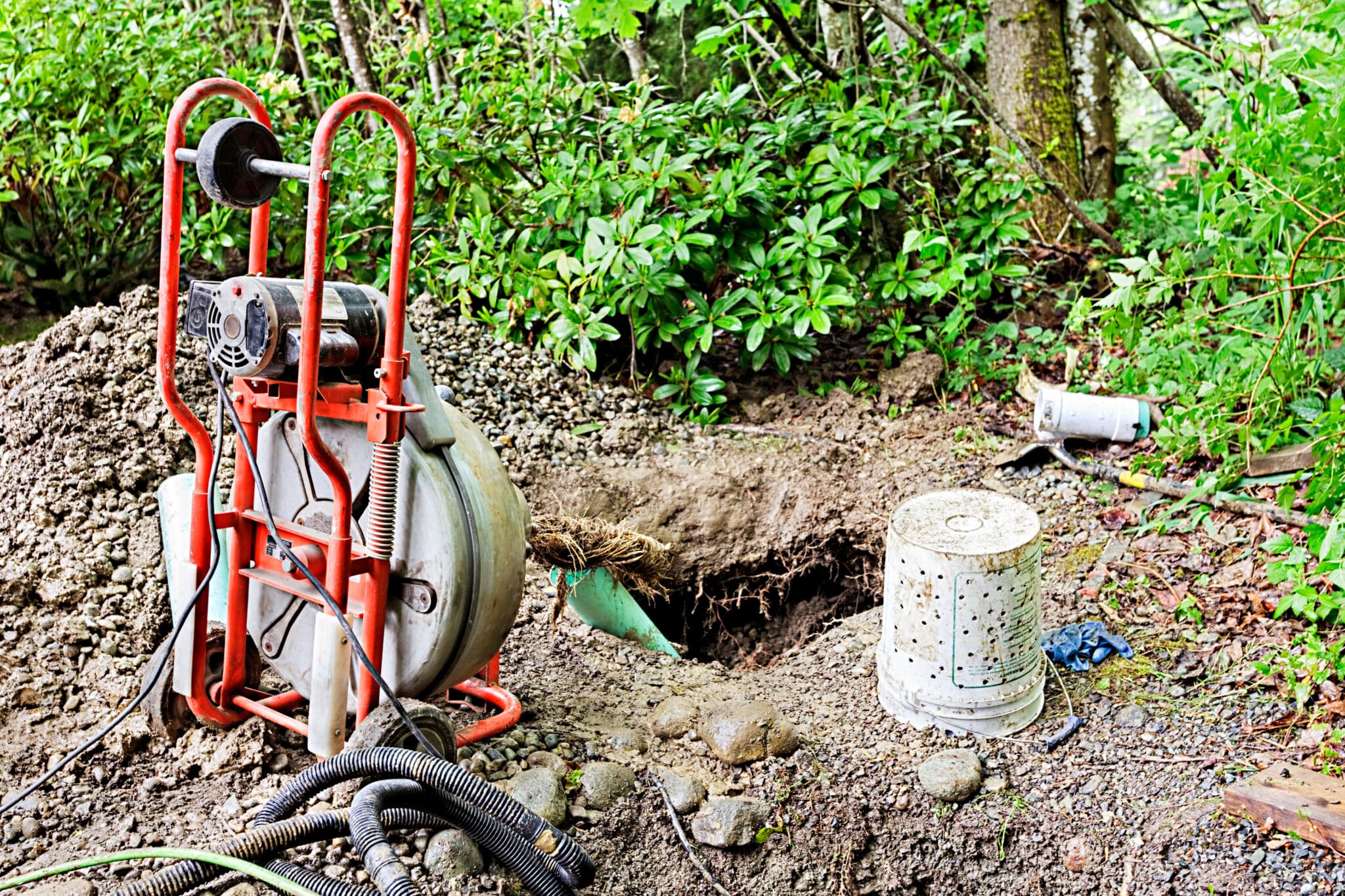Drain Root Removal Methods for Stubborn Blockages 1 Removing tree roots from groundwater drainage pipe in a back yard, Drain root removal.