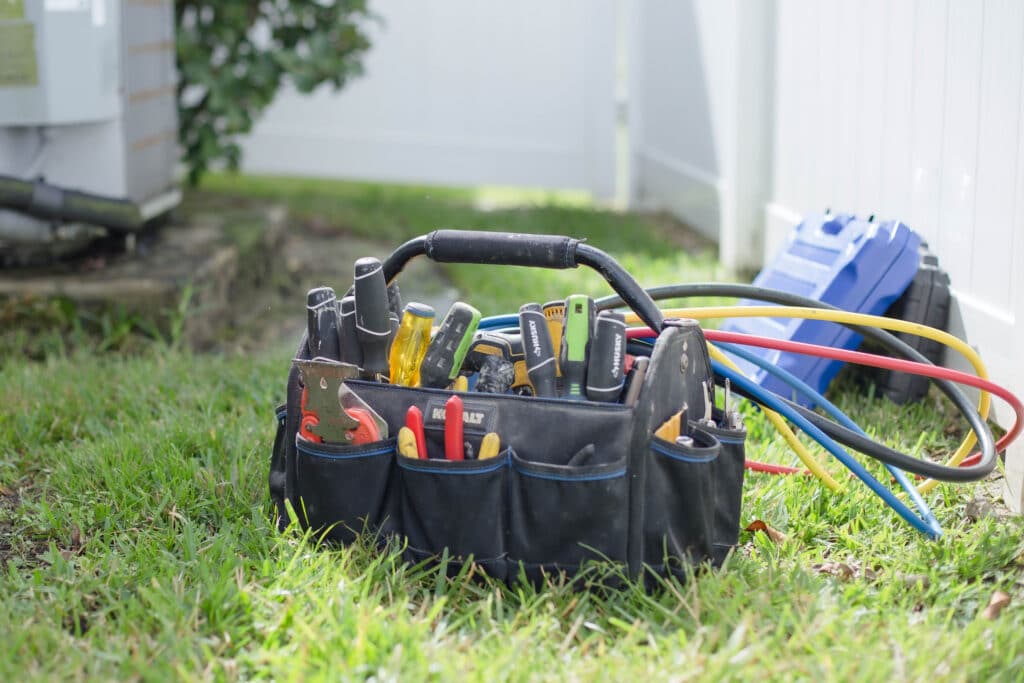 Heat pump maintenance checklist and tool bag for year-round HVAC comfort.