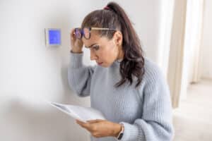 Woman shocked by rising energy bills without AC Overuse.